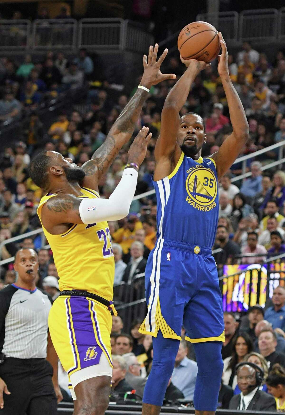 LAS VEGAS, NEVADA - OCTOBER 10: Kevin Durant #35 of the Golden State Warriors shoots against LeBron James #23 of the Los Angeles Lakers during their preseason game at T-Mobile Arena on October 10, 2018 in Las Vegas, Nevada. NOTE TO USER: User expressly acknowledges and agrees that, by downloading and or using this photograph, User is consenting to the terms and conditions of the Getty Images License Agreement. (Photo by Ethan Miller/Getty Images)