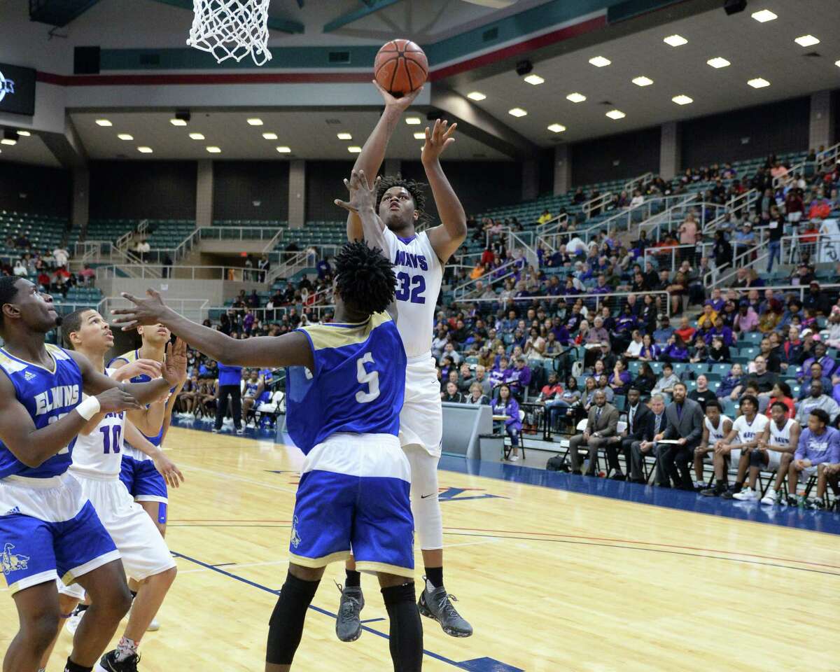 Eddie Lampkin (32) of Morton Ranch attempts a shot over Tyler Callegari (5) of Elkins during the second half of a Class 6A, Region III boy's basketball quarter final game between the Morton Ranch Mavericks and the Elkins Knights on Tuesday, February 26, 2019 at the Merrell Center, Katy, TX.