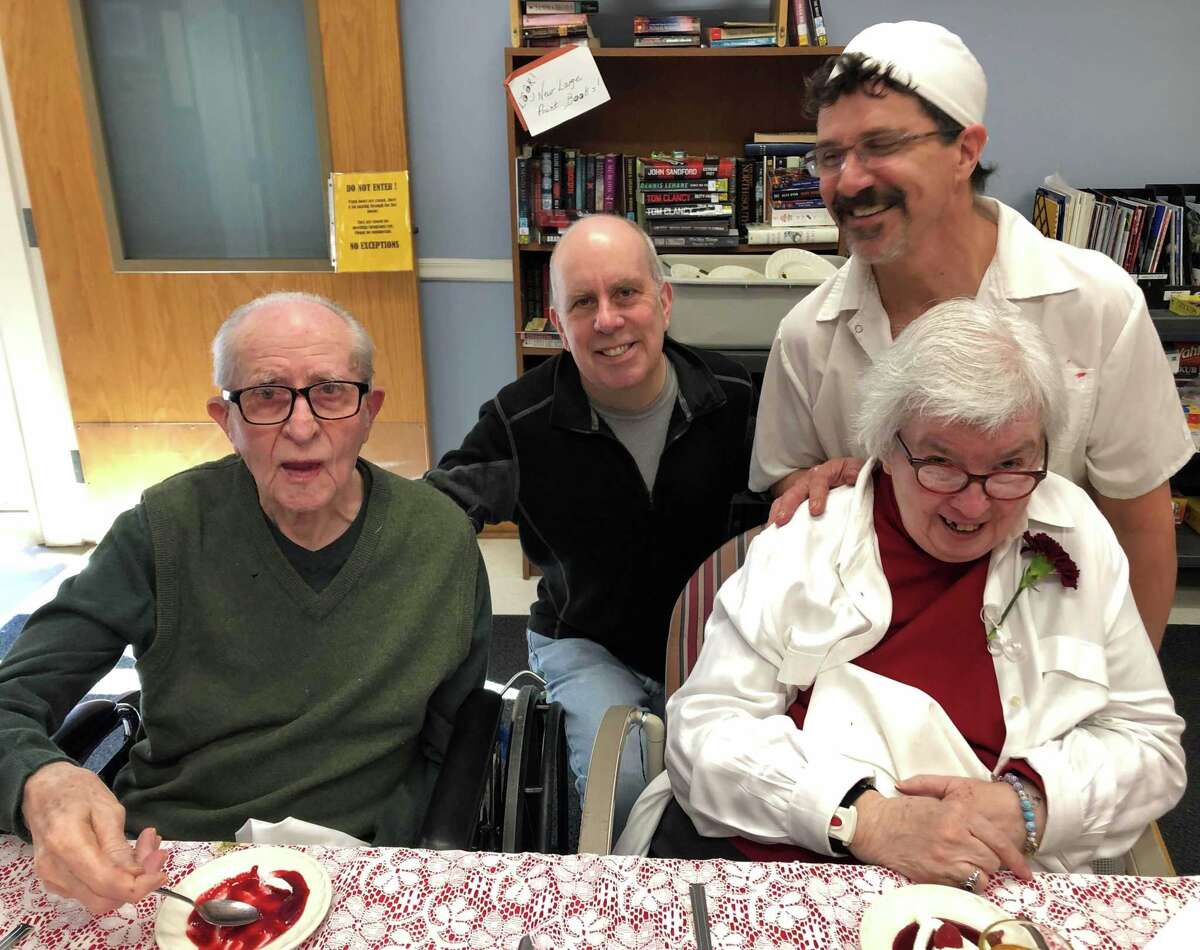 After enjoying lunch and music, Andy Csizmadia and his wife Sandy visit with their son Joe, back, and son-in-law cook Doug Williams.