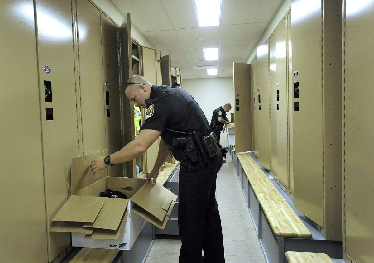 Bethel Police Officer Greg Emerson moves his belongings into his locker at the new Bethel Police Station on Judd Avenue in Bethel, Tuesday, Oct. 16, 2018.