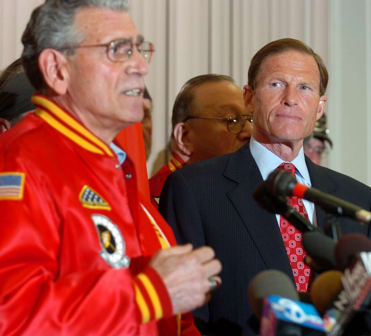 Attorney General Richard Blumenthal listens as Peter Galgano, of East Berlin, a member of the Marine Corps League, speaks at the Hannon-Hatch VFW, in West Hartford, Conn. Tuesday, May 18th, 2010. Blumenthal held a news conference to address a New York Times article that accused him of misstating his Vietnam War service, yet failed to mention his six years in the reserves.