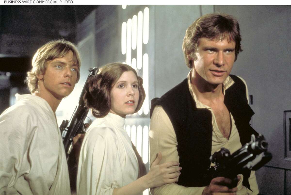 Luke Skywalker (Mark Hamill), Princess Leia (Carrie Fisher) and Han Solo (Harrison Ford) attempt to escape the clutches of Darth Vader aboard the Death Star in a scene from Star Wars: Episode IV A New Hope, coming to DVD on Sept. 21 from Lucasfilm Ltd. and Twentieth Century Fox Home Entertainment. (c)Lucasfilm Ltd. & . All rights reserved.