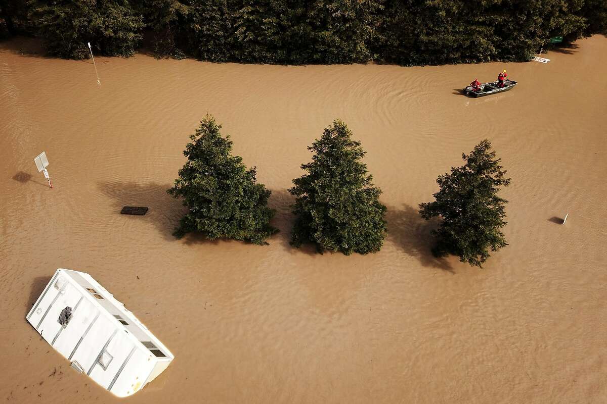 A Forestville Fire Department boat searches along River Road and Maribel Road on Wednesday, Feb. 27, 2019, in Forestville, Calif.
