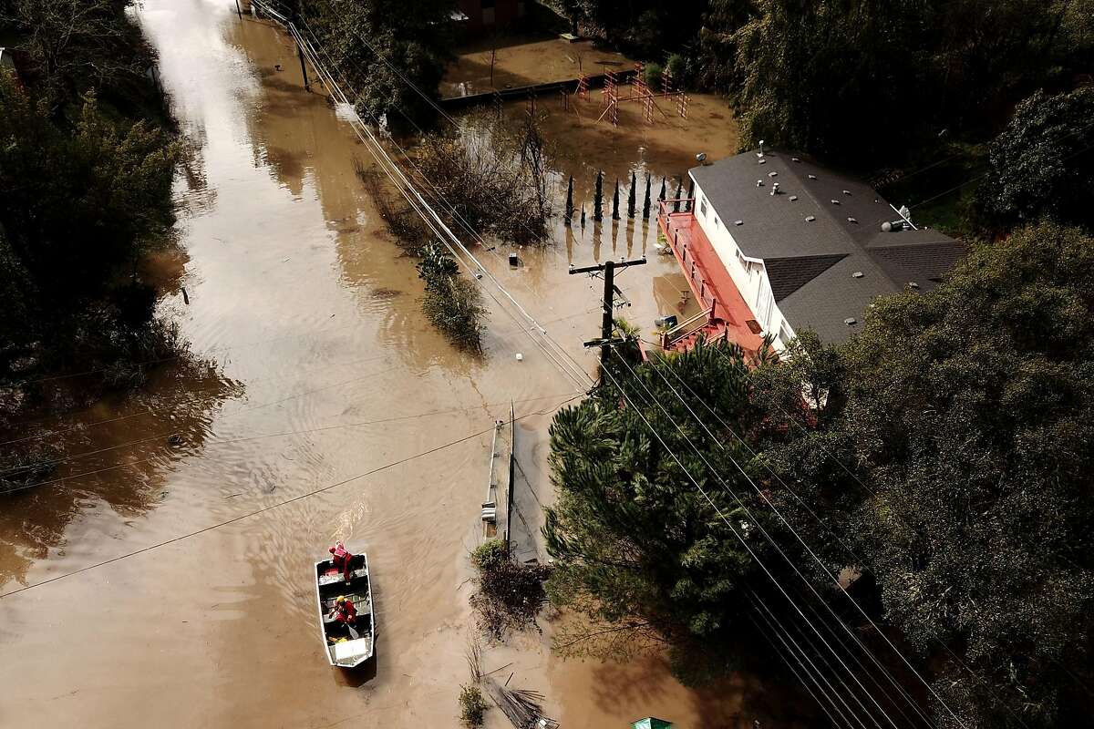 A Forestville Fire Department boat searches along Maribel Road and River Road on Wednesday, Feb. 27, 2019, in Forestville, Calif.
