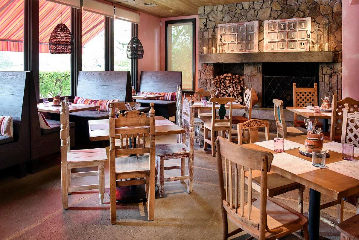 Mismatched decorative wooden chairs and booth seating in the dinning room at La Calenda restaurant in Yountville, Calif., on Wednesday February 27, 2019.