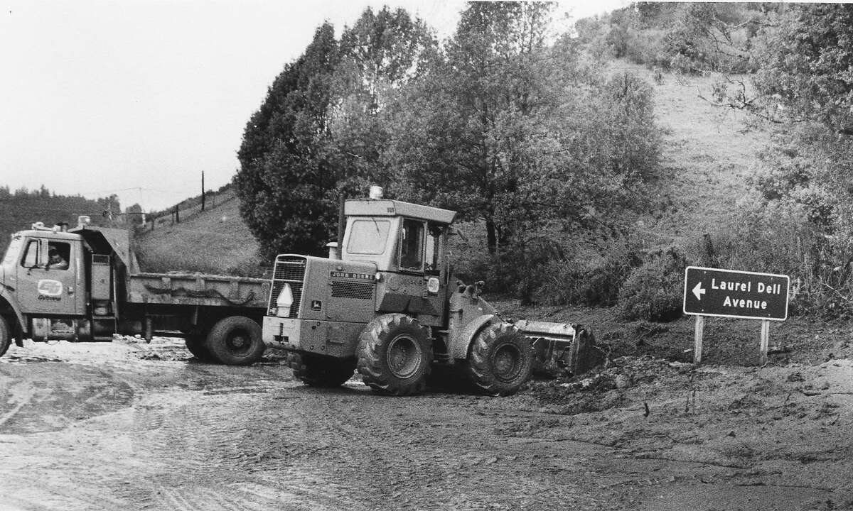 South of Guerneville on River Road Caltrans workers are removing mud from the highway across from Laurel Dell Ave, February 20, 1986