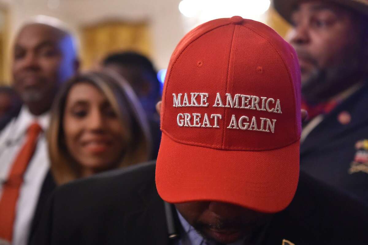 A man wearing a "Make American Great Again" (MAGA) cap awaits the start of a White House reception in honor of National African American History Month hosted by US President Donald Trump and first lady Melania on February 21, 2019 in Washington, DC. (Photo by Nicholas Kamm / AFP)NICHOLAS KAMM/AFP/Getty Images