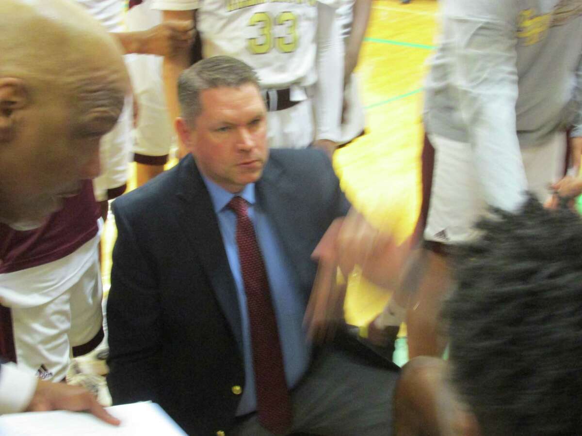 Sacred Heart coach Jon Carroll makes sure his defense stays on point in the Hearts' NVL Tournament championship win over Torrington Wednesday night at Wilby High School.