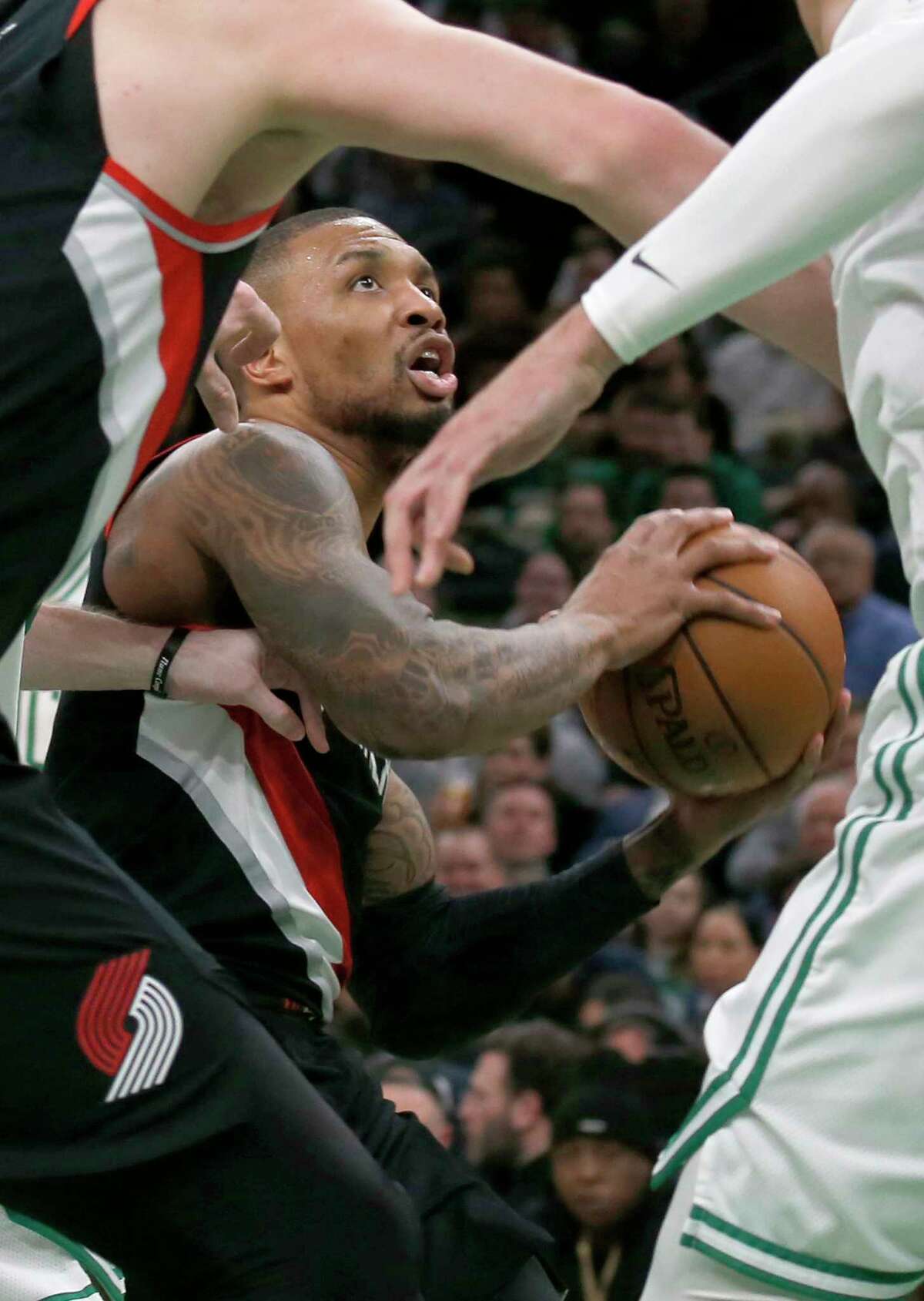 Portland Trail Blazers guard Damian Lillard drives to the basket through teammates and Boston Celtics defenders during the second half of an NBA basketball game Wednesday, Feb. 27, 2019, in Boston. (AP Photo/Mary Schwalm)