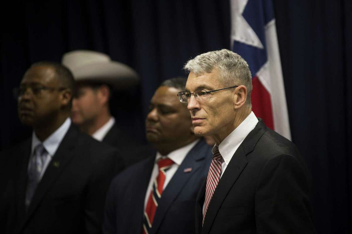 Steve McCraw, right, director of the Texas Department of Public Safety and FBI's Houston Division special agent in charge Perrye K. Turner, joined Texas Governor Greg Abbott, left, to announce a new plan against gang violence, Monday, April 10, 2017, in Houston. ( Marie D. De Jesus / Houston Chronicle )