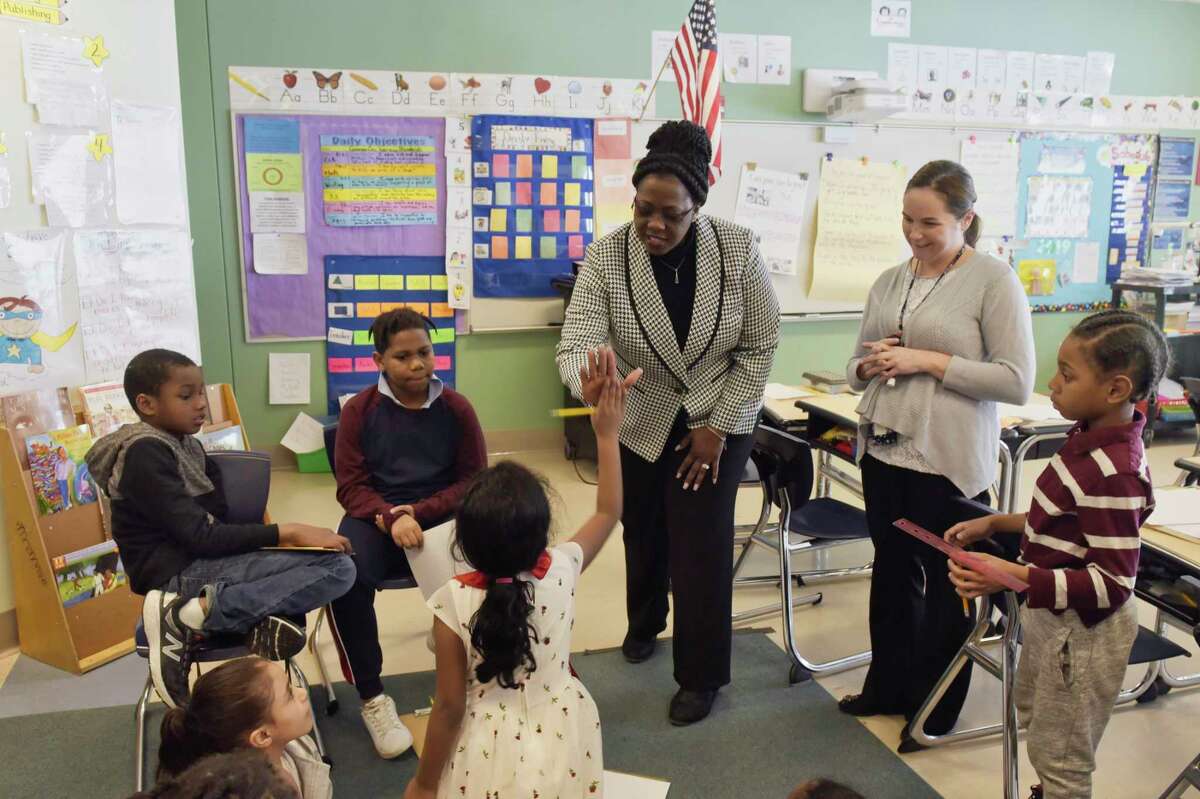 Albany schools superintendent Kaweeda Adams gives a high five to a third grade student in Erin Heid's class at Arbor Hill Elementary School on Wednesday, Jan. 23, 2019, in Albany, N.Y. (Paul Buckowski/Times Union)