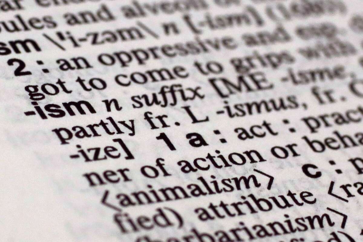 The suffix "ism" is photographed in Merriam-Webster's Collegiate Dictionary, in New York, Monday, Dec. 14, 2015. Merriam-Webster has picked a small but powerful suffix as word of the year: ism. The top isms to earn high traffic spikes and big bumps in lookups on the dictionary company's website in 2015 over the year before are socialism, fascism, racism, feminism, communism, capitalism and terrorism. (AP Photo/Richard Drew)