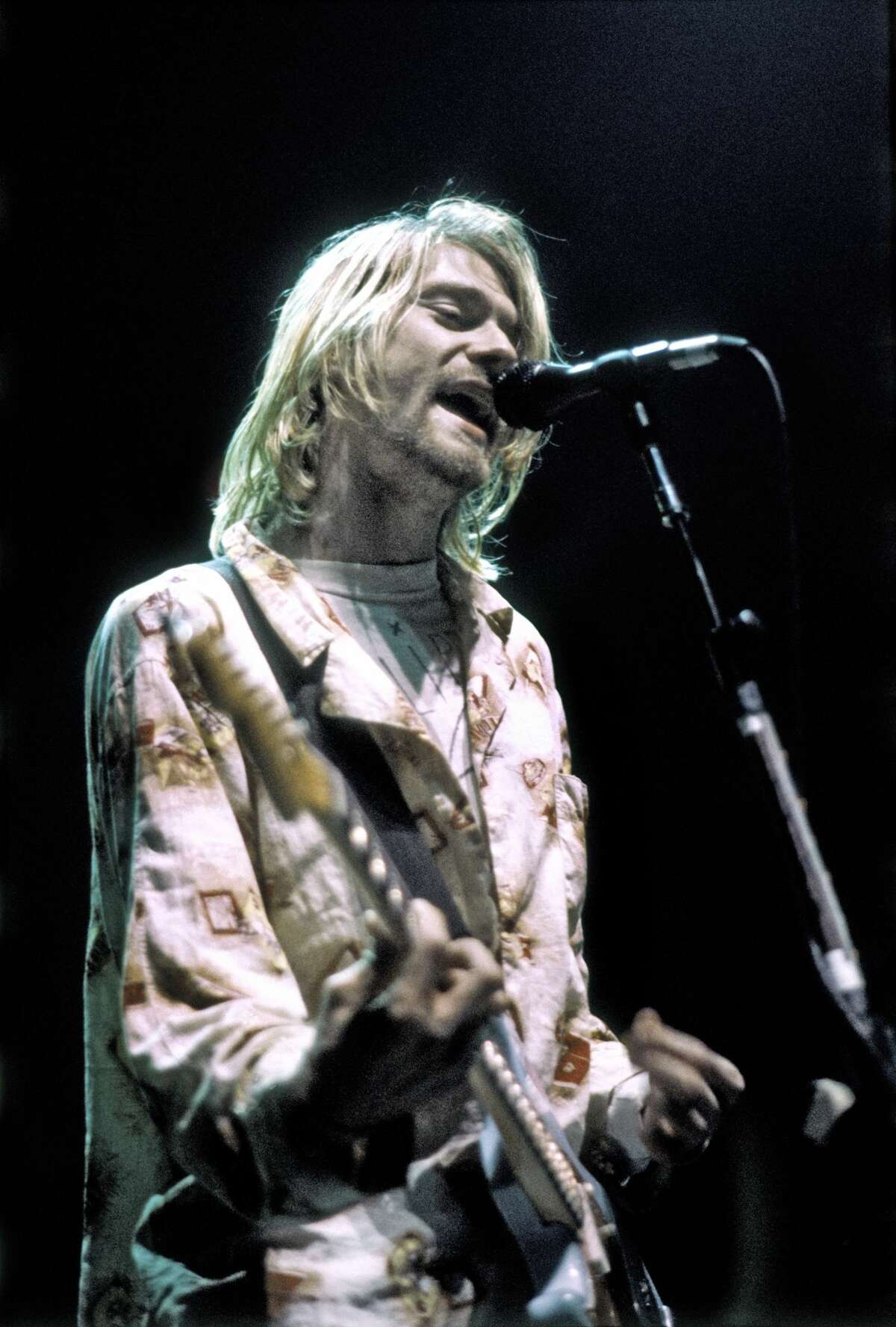 Rock musician Kurt Cobain of Nirvana plays his last US concert at the Seattle Arena on January 7, 1994 in Seattle, Washington. (Photo by Michael Ochs Archives/Getty Images)