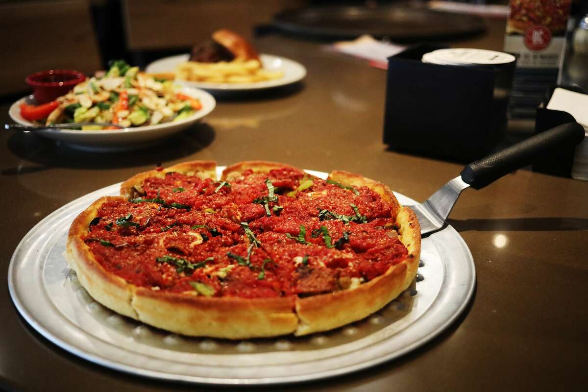 The deep dish Chicago 7 pizza with sauce on top is seen inside Old Chicago Pizza & Taproom, located at 6603 Eastman Ave., on Thursday, Feb. 28, 2019 in Midland. (Katy Kildee/kkildee@mdn.net)