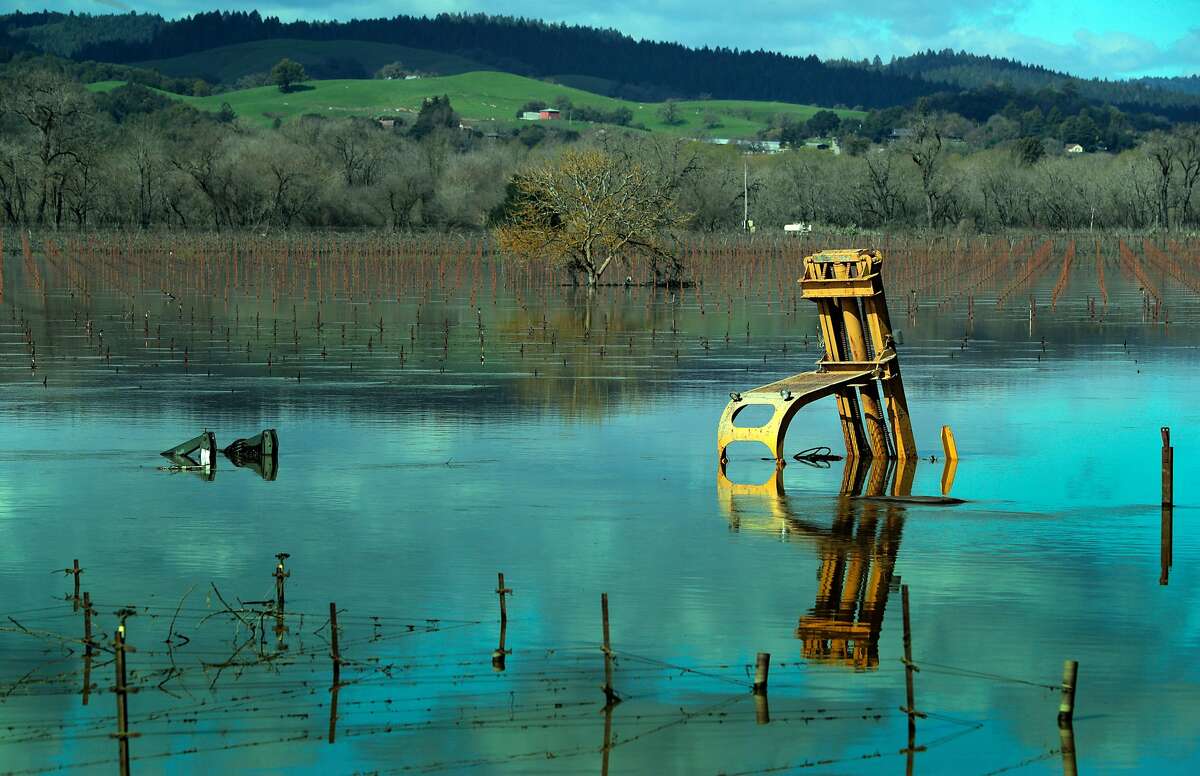 Farm equipment sits in a flooded vineyard on Westside Road near Forestville, Calif., on Thursday, February 28, 2019. The area along the Russian River sustained heavy flooding after an atmospheric river dumped almost 20 inches of rain in two days.