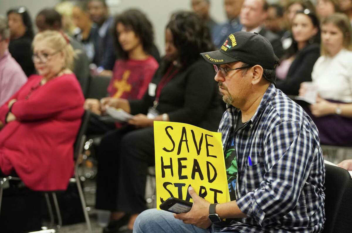 Amaury Mercato holds a sign that read "Save Head Start" during the Harris County Dept. of Education board meeting Wednesday, Feb. 27, 2019, in Houston.