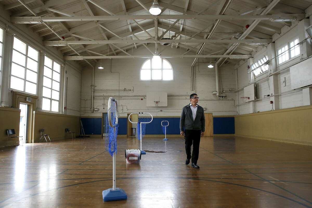 Principal Richard Zapien, walks the floor of the gymnasium, where the shelter would be located at Buena Vista Horace Mann K-8 school in San Francisco, Calif. This San Francisco public school is considering opening a family homeless shelter in one of the gyms to house students and their families who are homeless or need emergency shelter.