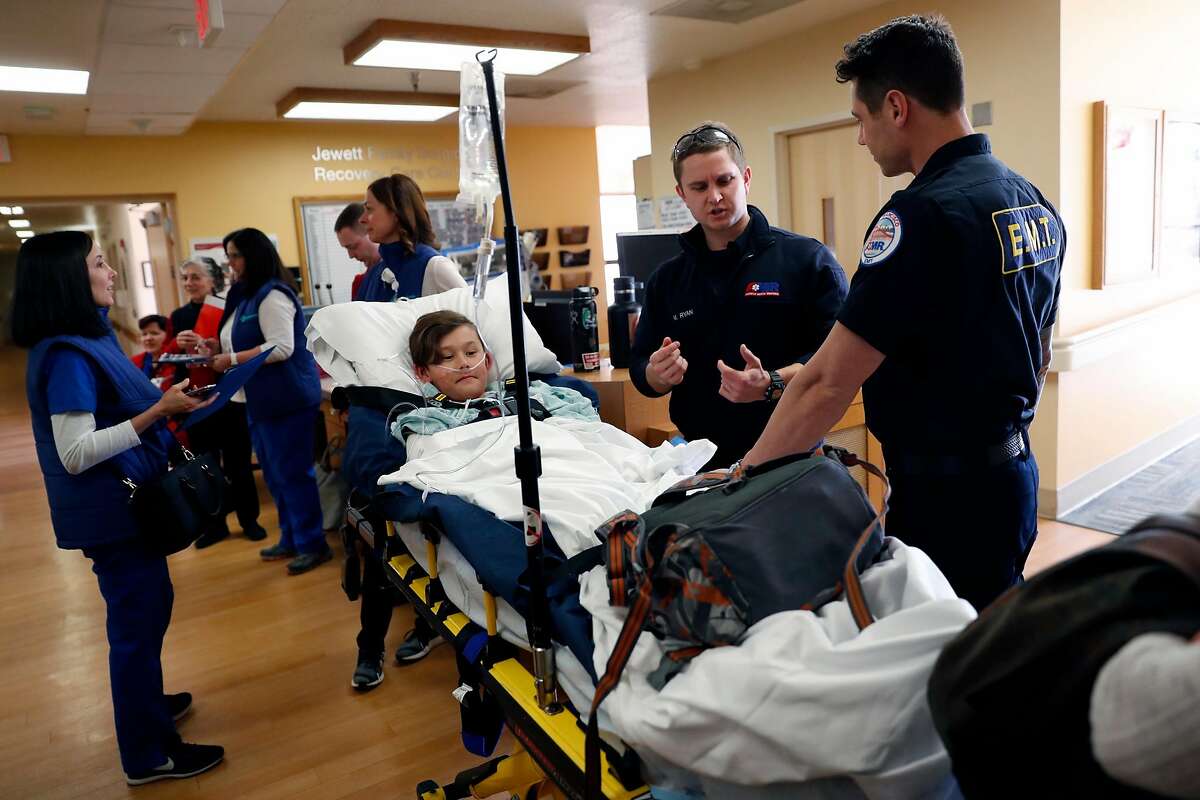 Jinoo Choi, 10, portrays a pediatric patient as EMT's Matt Ryan and Cameron Fletcher prepare to transport Choi as Sutter Health CPMC California campus practices moving patients in advance of move to new Van Ness Avenue building in San Francisco, Calif., on Thursday, February 21, 2019.