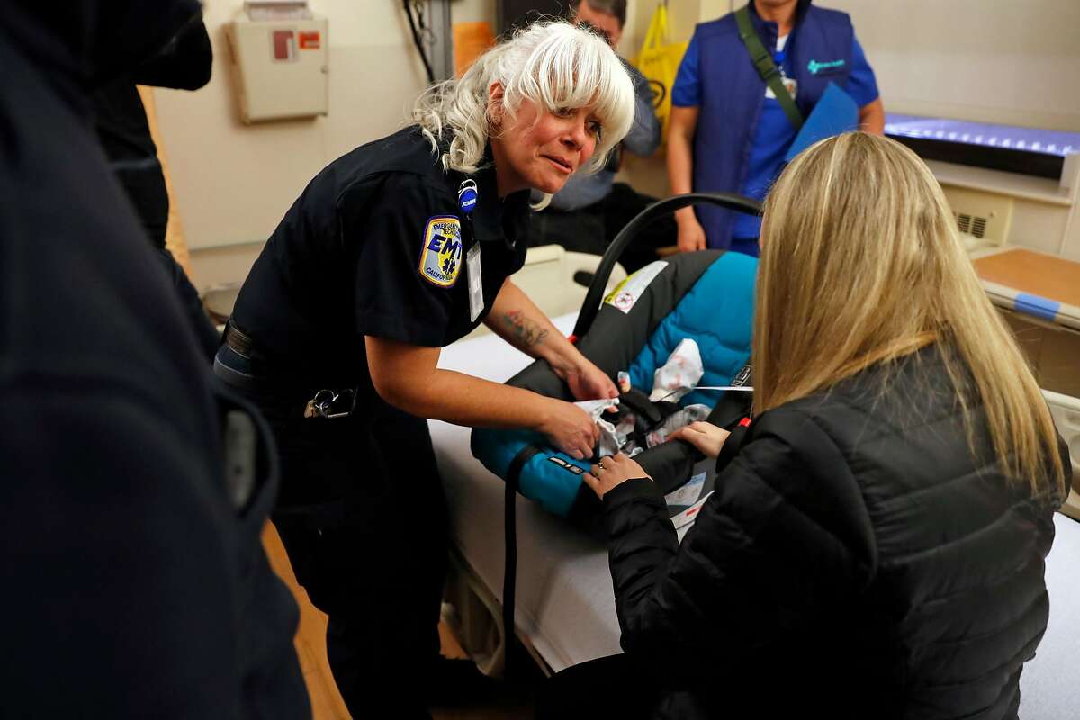 AMR EMT Melanie Brouhard rehearses transporting a "baby" as Sutter Health CPMC California campus practices moving patients in advance of move to new Van Ness Avenue building in San Francisco, Calif., on Thursday, February 21, 2019.