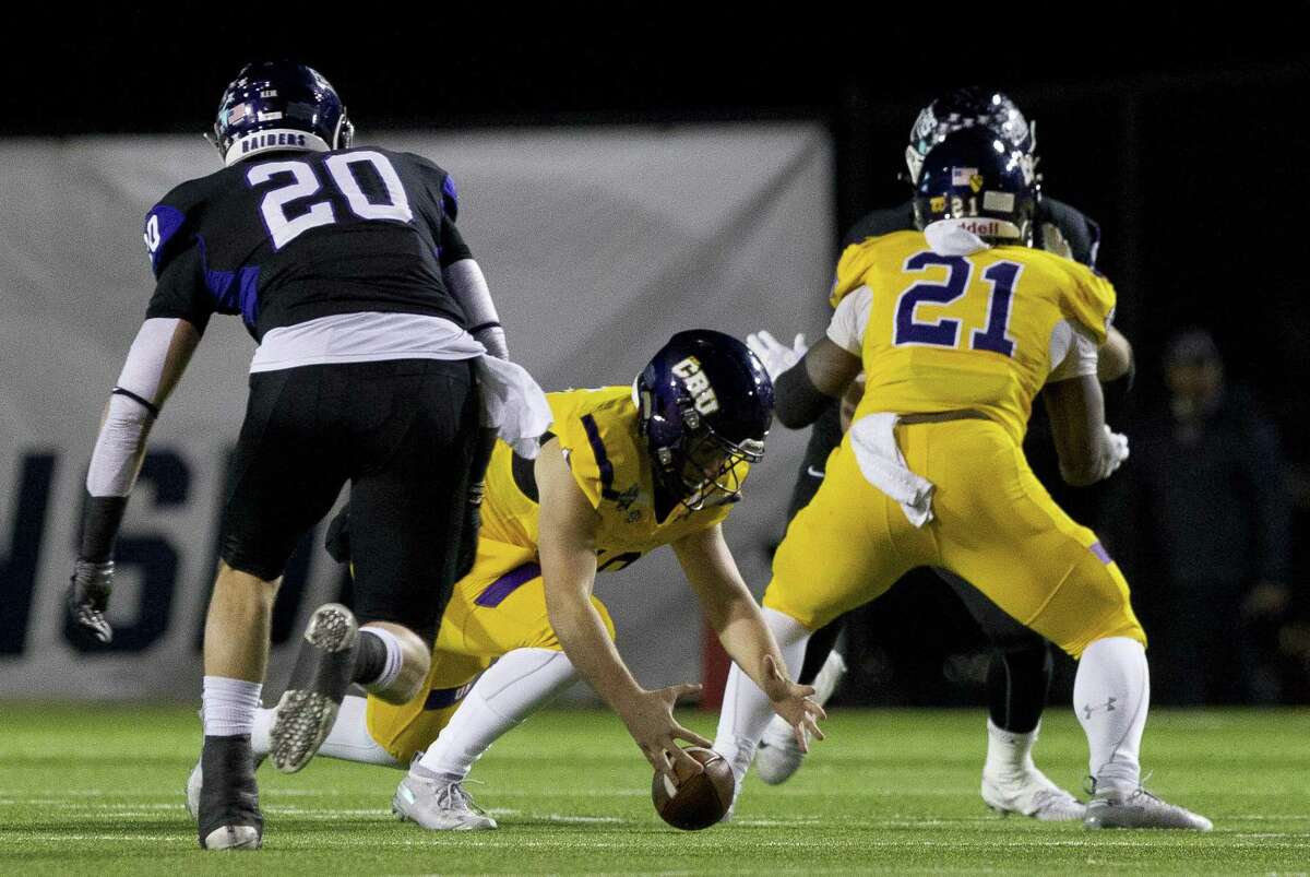 Mary Hardin-Baylor quarterback Jase Hammack (18) fumbles the ball during the first quarter of the Stagg Bowl NCAA Division III college football championship at Woodforest Bank Stadium, Friday, Dec. 14, 2018, in Shenandoah. Mount Union defensive back Austin White (20) recovered the fumble.