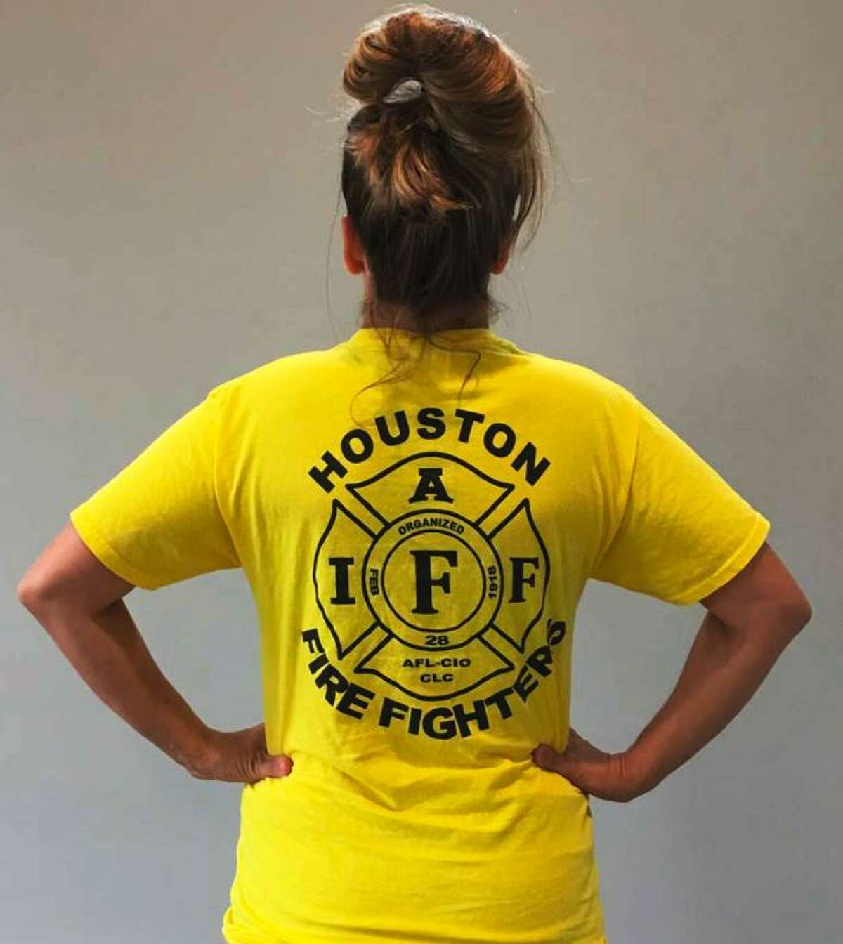Jillian Ostrewich, who is married to a Houston firefighter, is pictured wearing the T-shirt she wore to a Harris County polling place for early voting in October 2018, when a pay parity measure for firefighters was on the ballot. According to court documents, election officials told her she could not cast her vote with the logo showing, so she turned her T-shirt inside out and was able to proceed.
