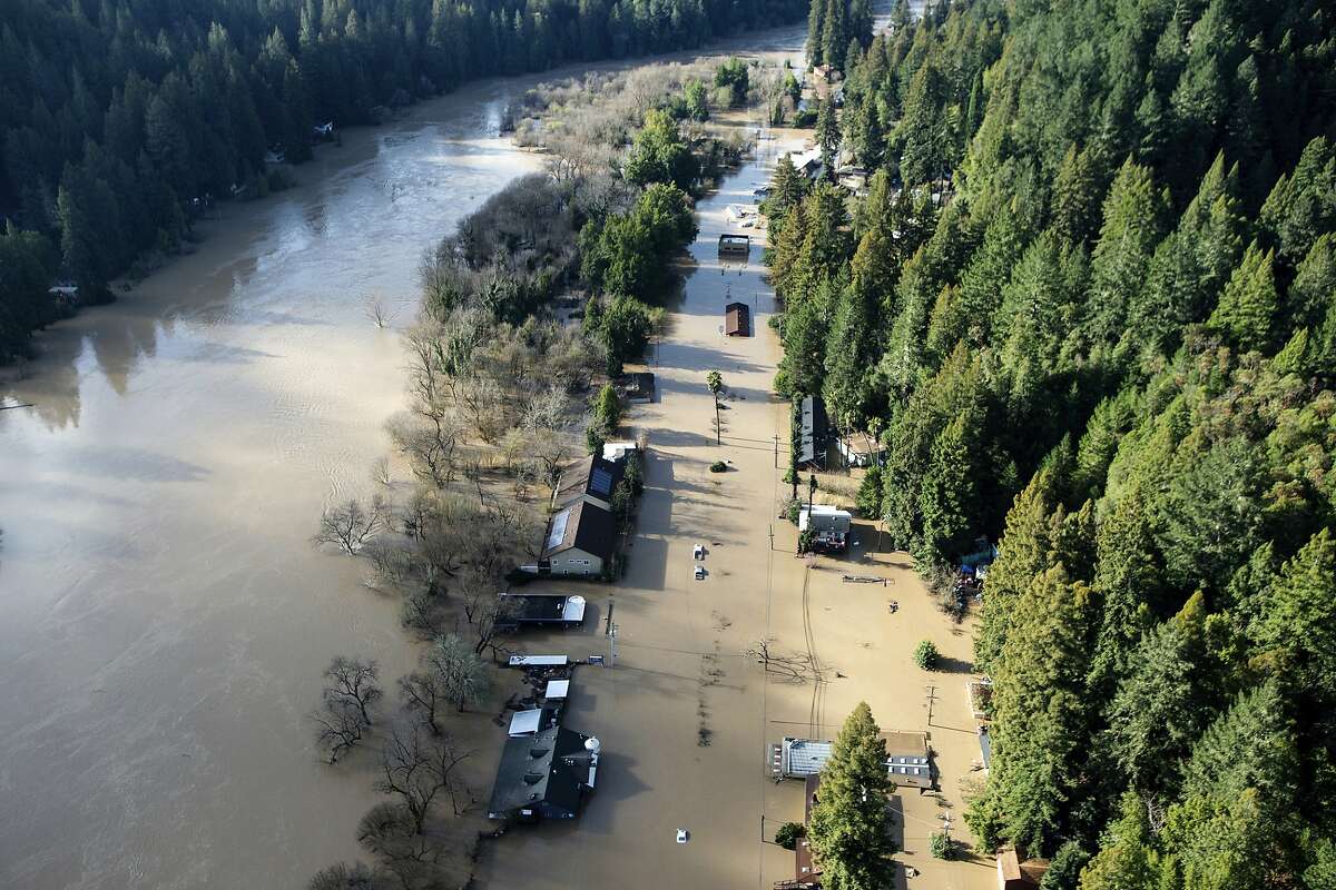 Flood waters from the Russian River partially submerge properties in Guerneville, Calif., on Thursday, Feb. 28, 2019. The river in the wine country north of San Francisco reached its highest level in 25 years Wednesday night and Sonoma County officials say it won't return to its banks until late Thursday. (AP Photo/Josh Edelson)