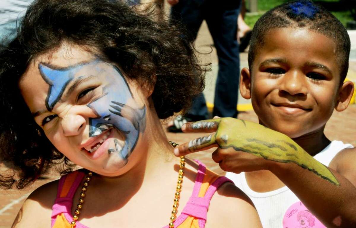 L-R: Mackylie Race, age 6, of Hudson and her 7 year old cousin, Dejawn Crooks, of Albany, show off their face paints they received at GE Kids Day on Sunday, July 18, 2010, at the Empire State Plaza in Albany, NY. Race has a shark on her face, while Crooks sports an alligator on his arm. The General Electric sponsored event treated children to bouncy bounce setups, food, a petting zoo, pony rides, crafts, characters to meet & face painting for the day. (Luanne M. Ferris / Times Union)