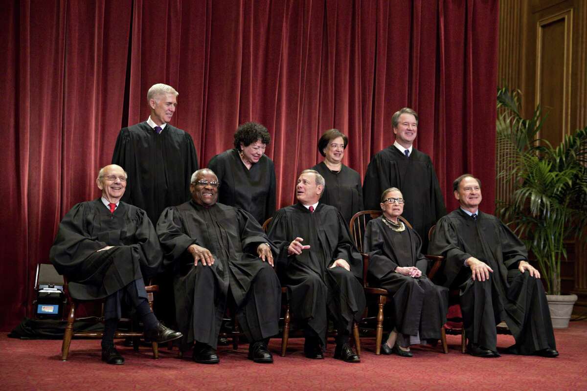 Justices of the U.S. Supreme Court pose during their formal group photograph in the East Conference Room of the Supreme Court in Washington on Nov, 30, 2018.