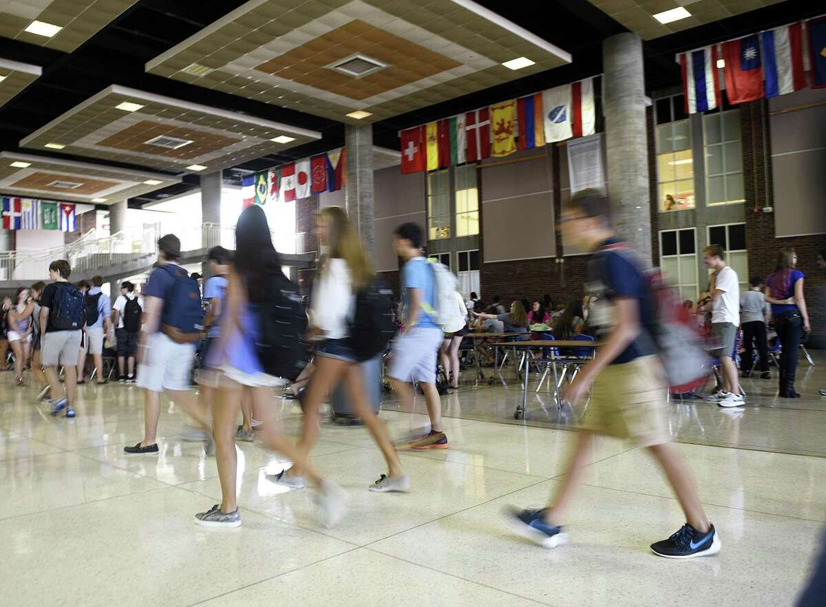 Students walk through the student center on the first day of school at Greenwich High School in Greenwich, Conn. Wednesday, Sept. 2, 2015.