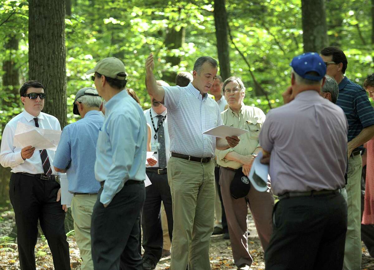 Joel Lindsay, center, with Ameresco Candlewood Solar LLC, leads a walking tour for the state Siting Council of the area where there is a proposal to build solar panels on Candlewood Mountain in New Milford, Tuesday, Sept. 26, 2017.