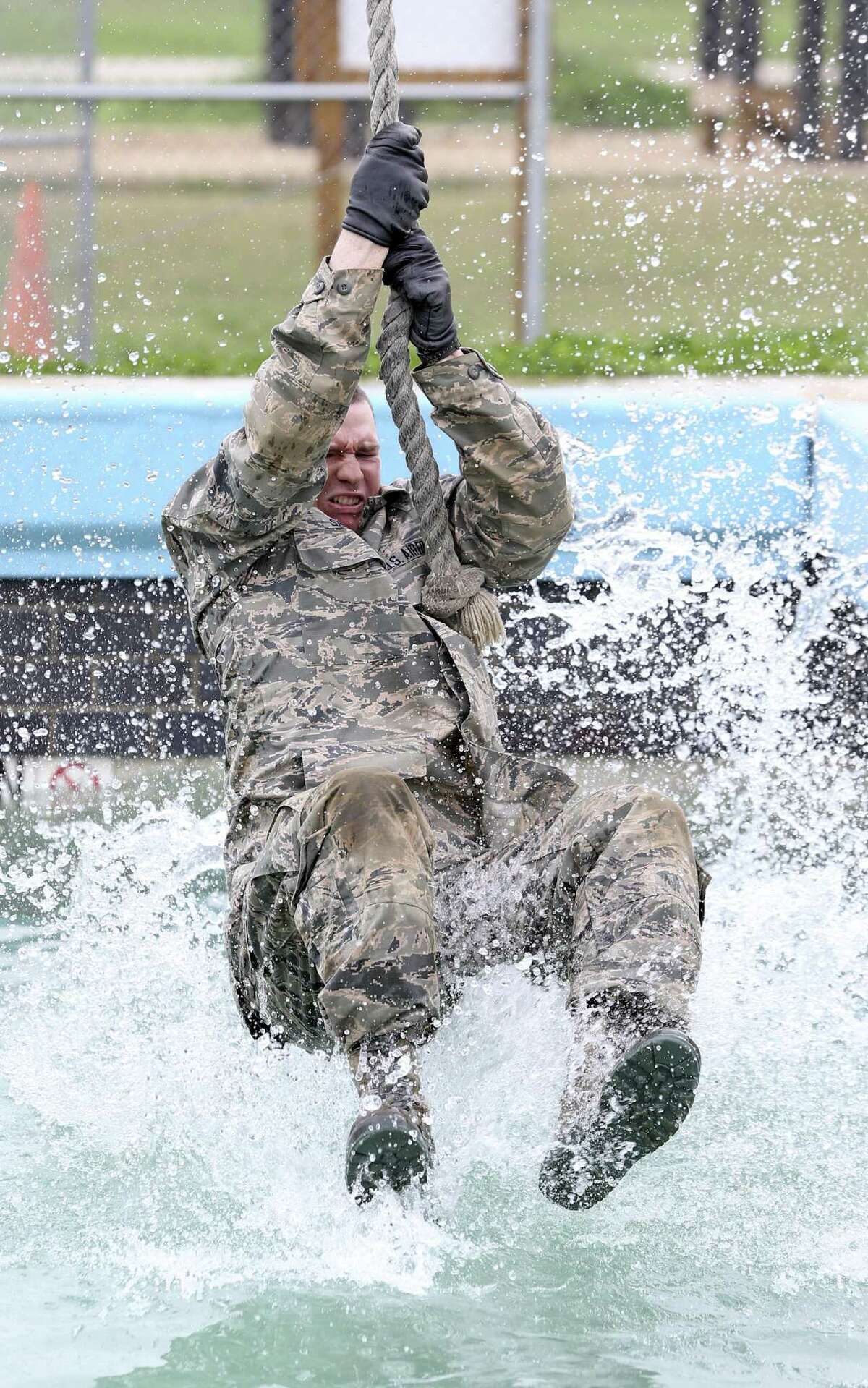 An Air Force recruit skims across the water in an exercise in the CLAW obstacle course, part of the BEAST program at Joint Base San Antonio-Lackland, on Feb. 6, 2019.
