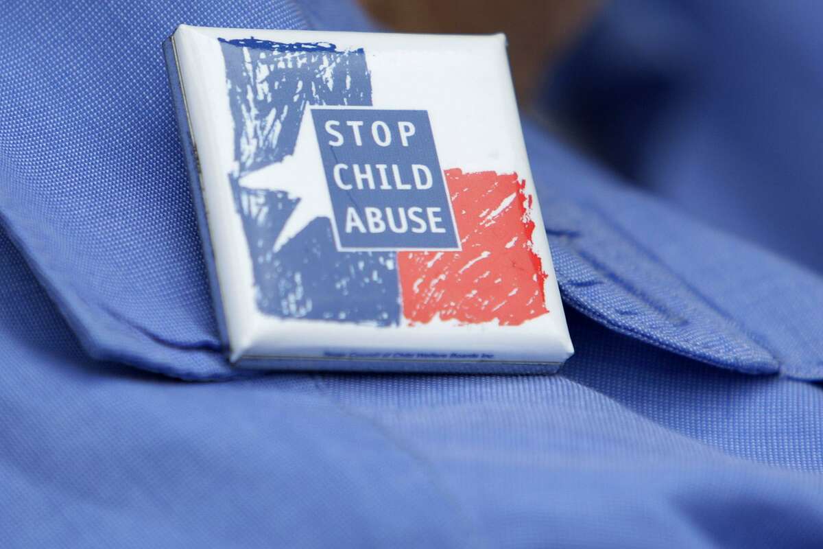 A participant wears a pin as members and volunteers of Texas CASA, Court Appointed Special Advocates, gather for a rally in front of the Bexar County Courthouse during Child Abuse Prevention Month, Monday, April 12, 2010. JThe rally was held to recruit more volunteers. In fiscal year 2009, 5,648 CASA volunteers worked with 19,818 children in Child Protective Services custody according to their press release. They said that this number represent less than half of the children needing help. ERRY LARA/glara@express-news.net