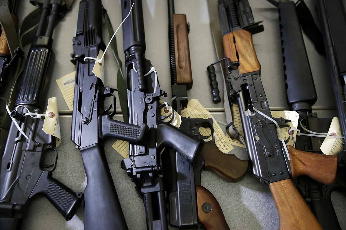FILE - In this Oct. 9, 2018, file photo, Illegally possessed firearms seized by authorities are displayed at a news conference in Los Angeles. Attorney General Xavier Becerra is set to unveil new 2018 numbers from a uniquely California program that seizes guns from people no longer allowed to own them. He's expected to acknowledge Friday, March 1, 2019, that a backlog of illegally held weapons remains despite an infusion of millions of dollars to beef up enforcement efforts in recent years. (AP Photo/Jae C. Hong, File)