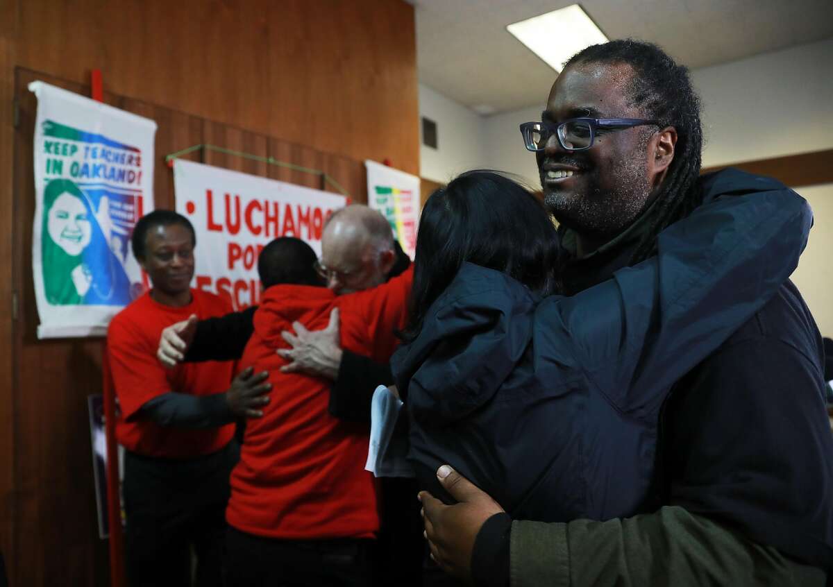 Keith Brown (right), president, Oakland Education Association, receives a hug from Mary Nicely, Senior Policy Advisor to the CA State Superintendent of Public Instruction, following a press conference that announced a tentative settlement has been reached in the Oakland teacher's strike at Taylor Memorial United Methodist in Oakland, Calif., on Friday, March 1, 2019.