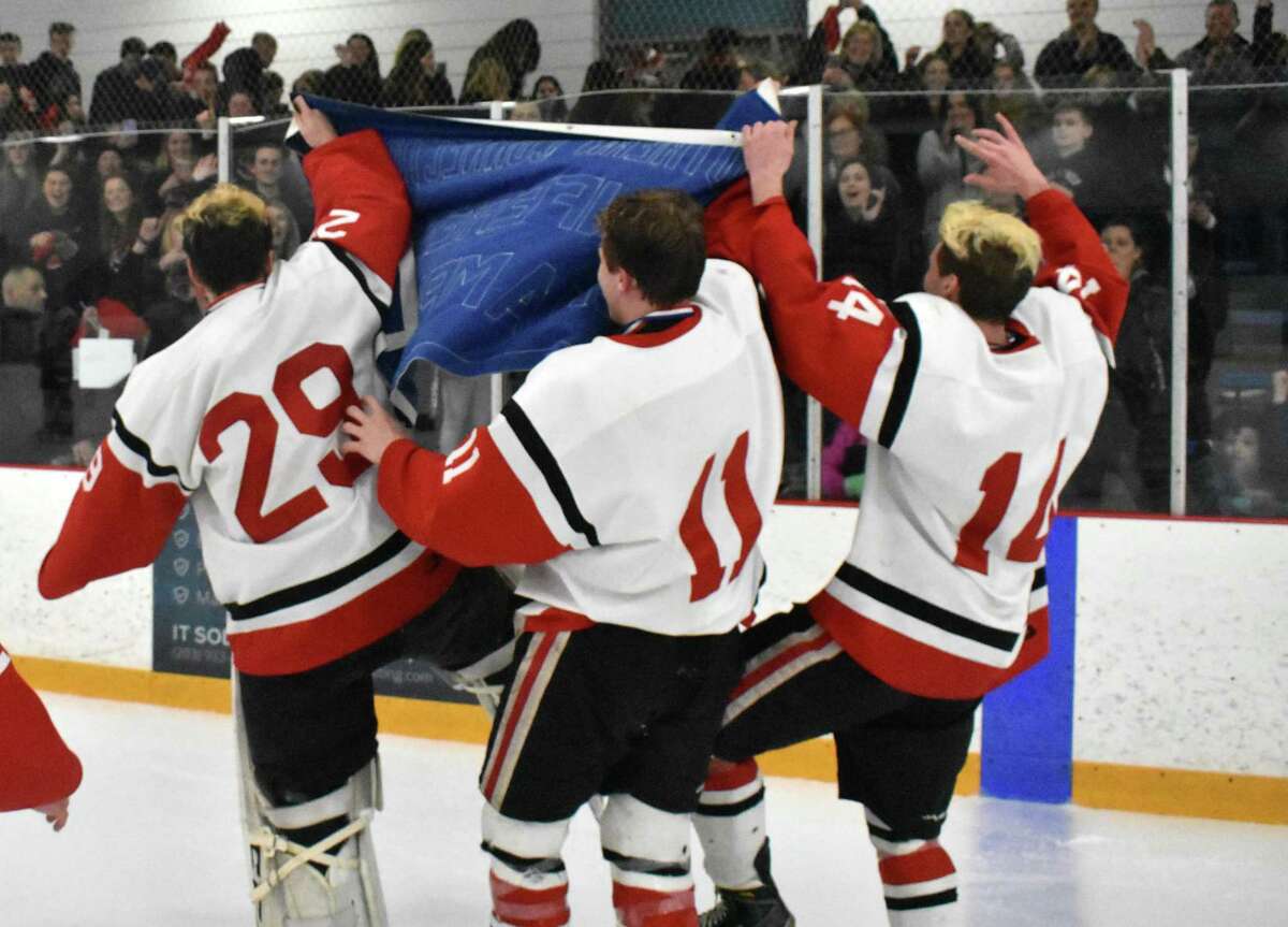 Branford celebrates winning the SCC/SWC Division II championships over Watertown-Pomperaug at Bennett Rink, West Haven. (Pete Paguaga, Hearst Connecticut Media)