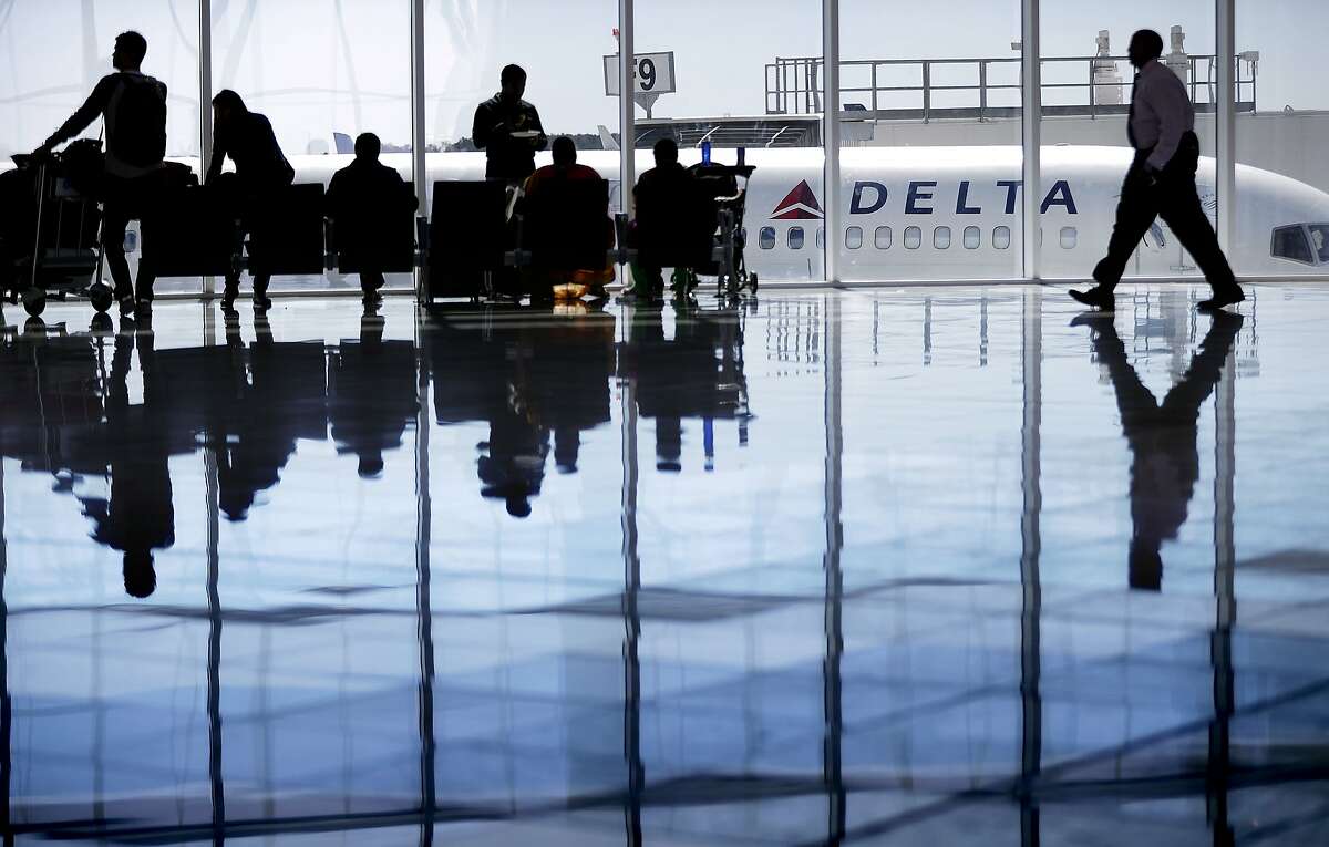 FILE - In this Oct. 13, 2016 file photo, a Delta Air Lines jet sits at a gate at Hartsfield-Jackson Atlanta International Airport, in Atlanta. (AP Photo/David Goldman)