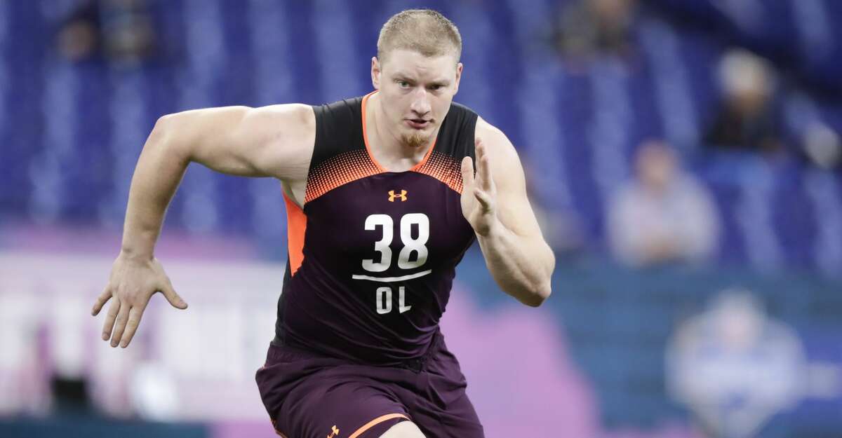 Washington offensive lineman Kaleb McGary runs a drill at the NFL football scouting combine in Indianapolis, Friday, March 1, 2019. (AP Photo/Michael Conroy)