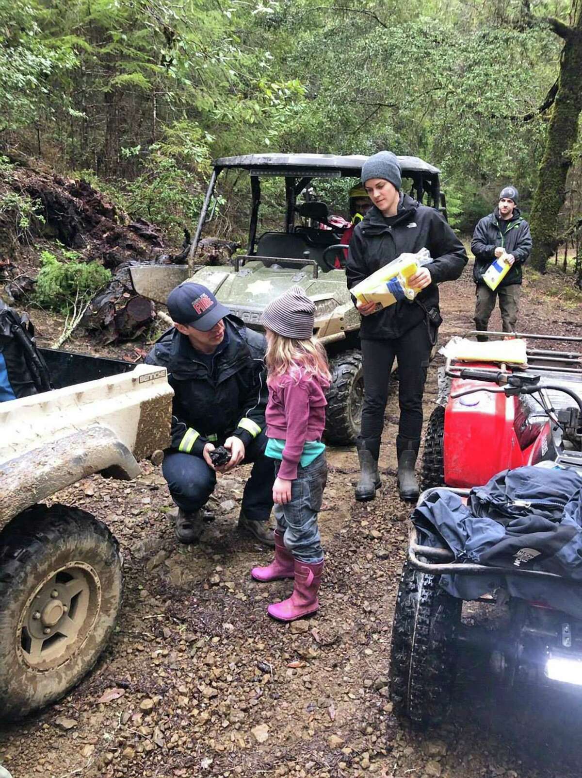 Caroline Carrico is assisted by first responders after she and her sister were found by volunteer firefighters in a park 1.4 miles from their home in Humboldt County. They sisters had been missing for nearly two days. Photo by Humboldt County Sheriff's Office