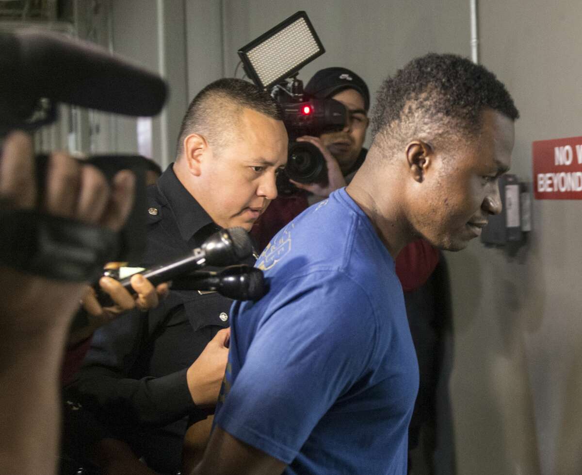 Active-duty US Air Force Maj. Andre McDonald, right, is escorted Sunday, March 3, 2019 to the Bexar County Magistrate center where where Sheriff Javier Salazar says he will be charged with tampering with evidence in the disappearance of his 29-year-old wife, Andreen Nicole McDonald.
