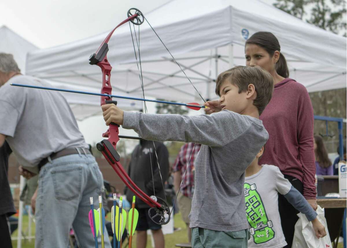 Quin Okeeffe, 7, pulls back on the strings of a bow at an archery range during the 15th Annual Texas Wildlife & Woodland Expo Spring Fling 2019 on Saturday, at Lone Star College-Montgomery in Conroe and Montgomery.