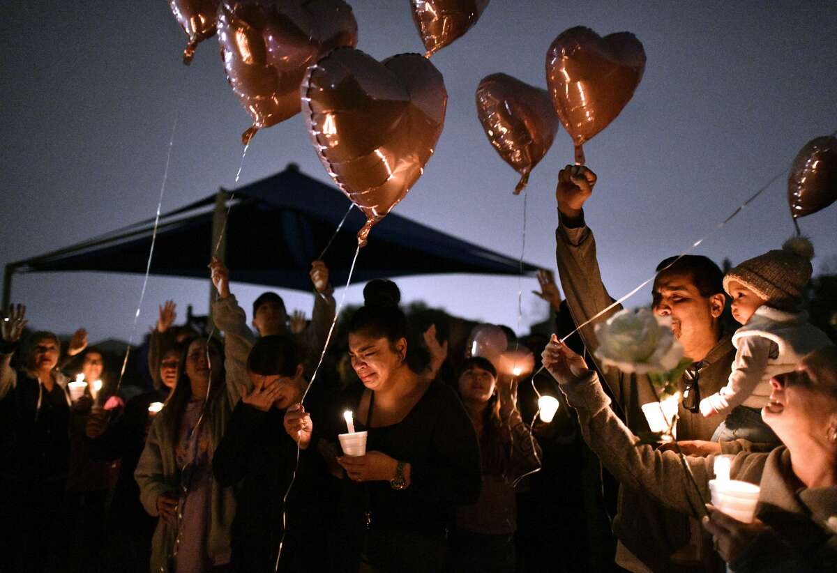 Sally De Leon, middle, older sister of Kaitlin Leonor Castilleja, 18, who allegedly was stabbed to death because of a social media feud, releases a balloon, along with other family members, during a vigil for her fallen sister on Friday night, March 1, 2019. A 16-year-old James Madison High School student has been arrested in the case.