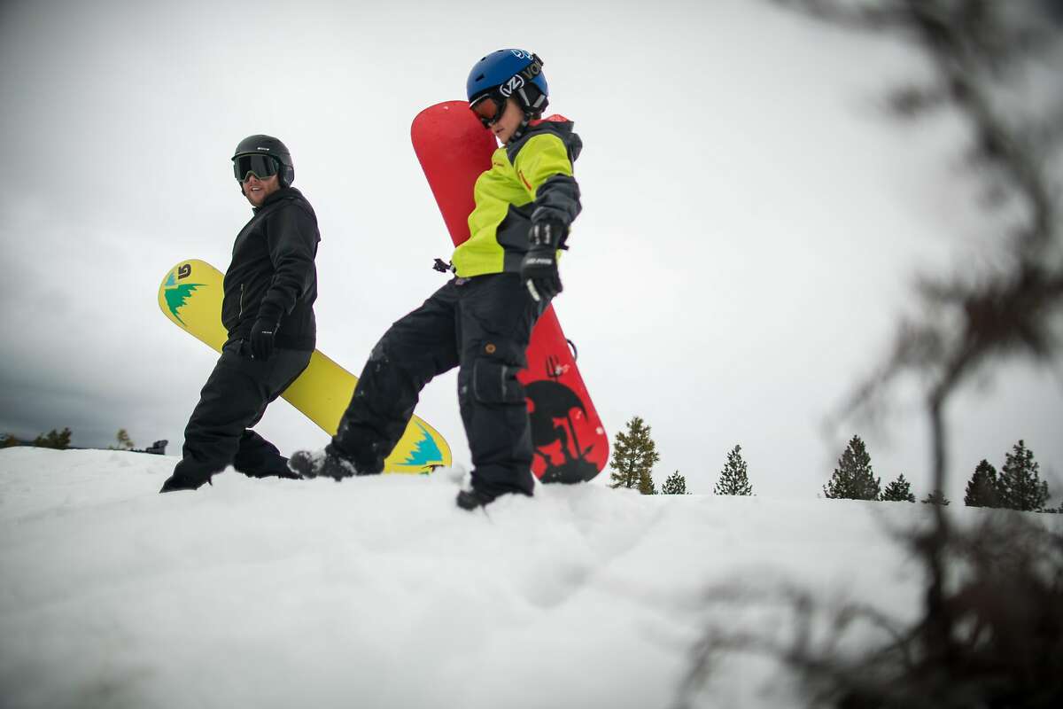 Bryan Allegretto shows his son, Jayce Allegretto, 8, how to snowboard just a few minutes from their Reno, Nevada home on Sunday March 3rd, 2019