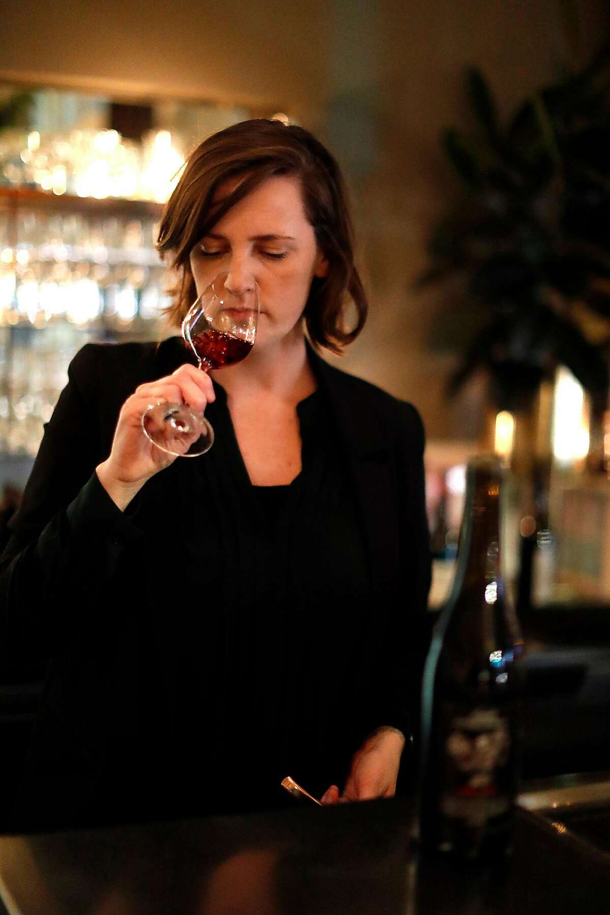 Louisa Smith, Lord Stanley wine director, checks the aroma of a glass of wine at the restaurant in San Francisco, Calif., on Wednesday, February 20, 2019.