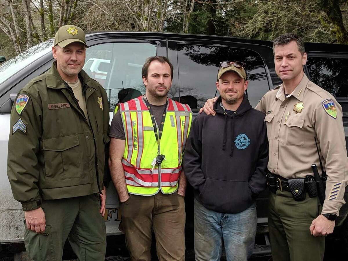 Delbert Chumley (second from left) and Abram Hill (second from right), volunteers from the Piercy Fire Department, pose with Humboldt County Sheriff's deputies after they found missing 5- and 8-year-old girls in a forested area near Richardson Grove State Park. Photo by Humboldt County Sheriff's Office