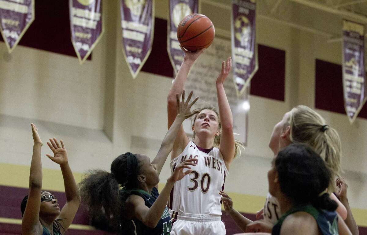Magnolia West power forward Hannah Eggleston (30) shoots over Bryan Rudder defenders during the second quarter of a District 19-5A high school basketball game at Magnolia West High School, Tuesday, Jan. 15, 2019, in Magnolia.