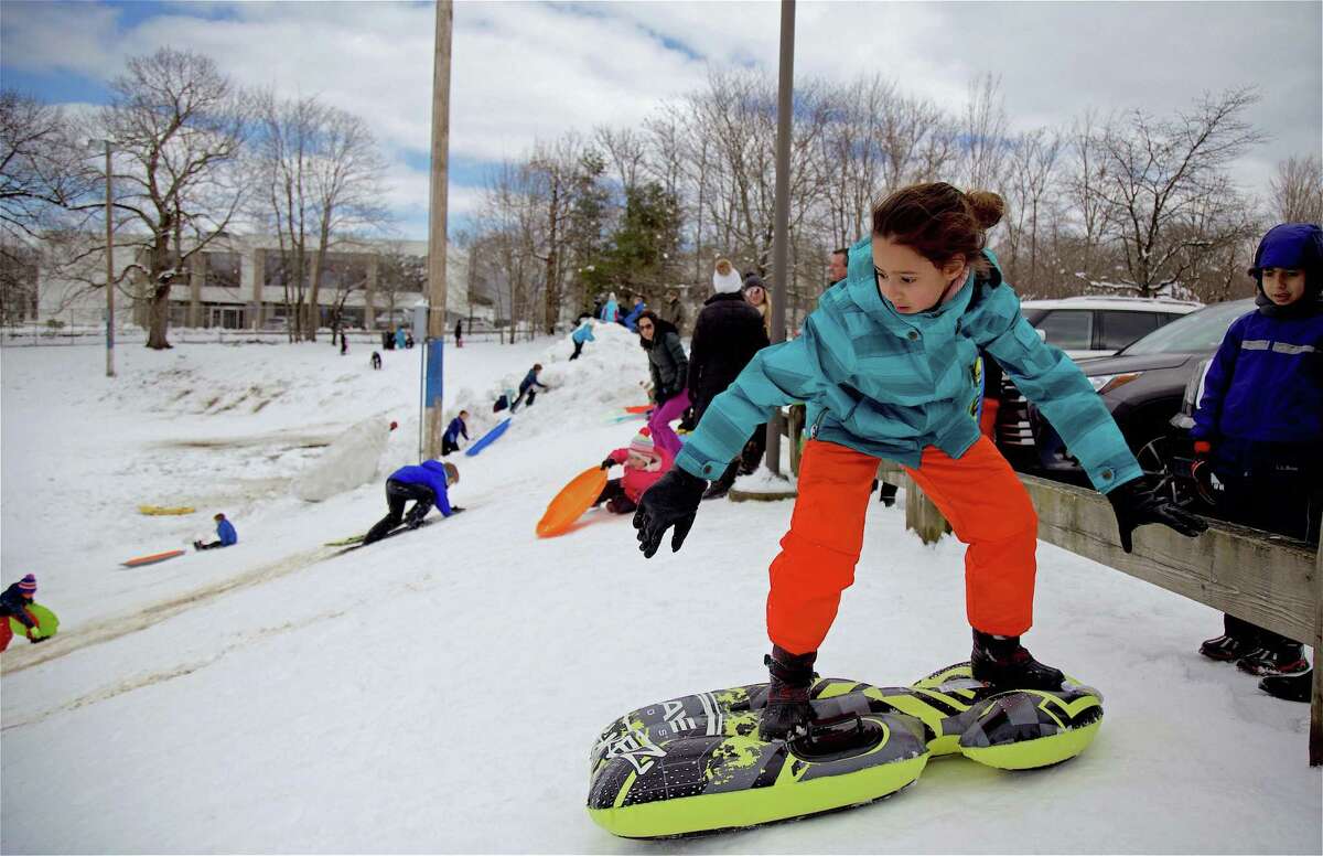 Manar Abis, 10, of Westport, gets ready to head down the hill while standing at Greens Farms School in March in Westport.