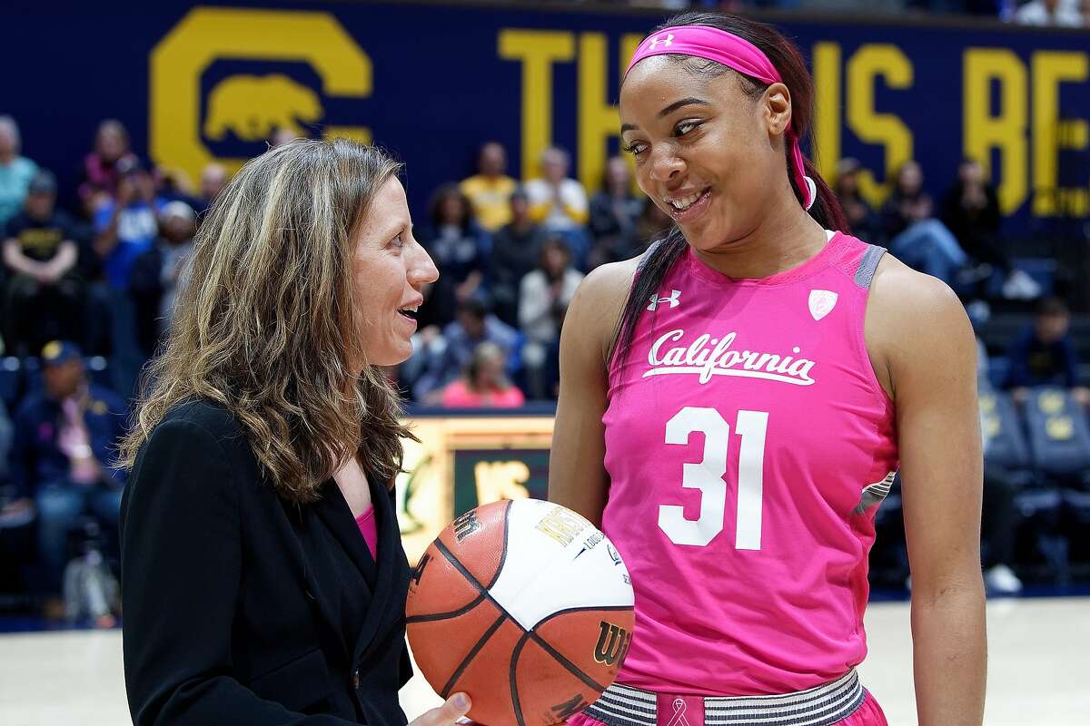 Cal head coach Lindsay Gottlieb presents Kristine Anigwe with a ball that commemorates her becoming the school's top scorer.