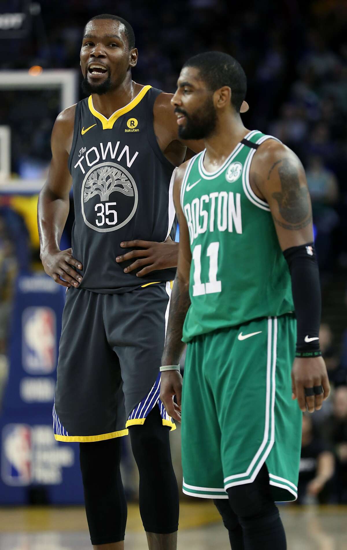 Golden State Warriors' Kevin Durant and Boston Celtics' Kyrie Irving during Warriors' 109-105 win in NBA game at Oracle Arena in Oakland, Calif., on Saturday, January 27, 2018.