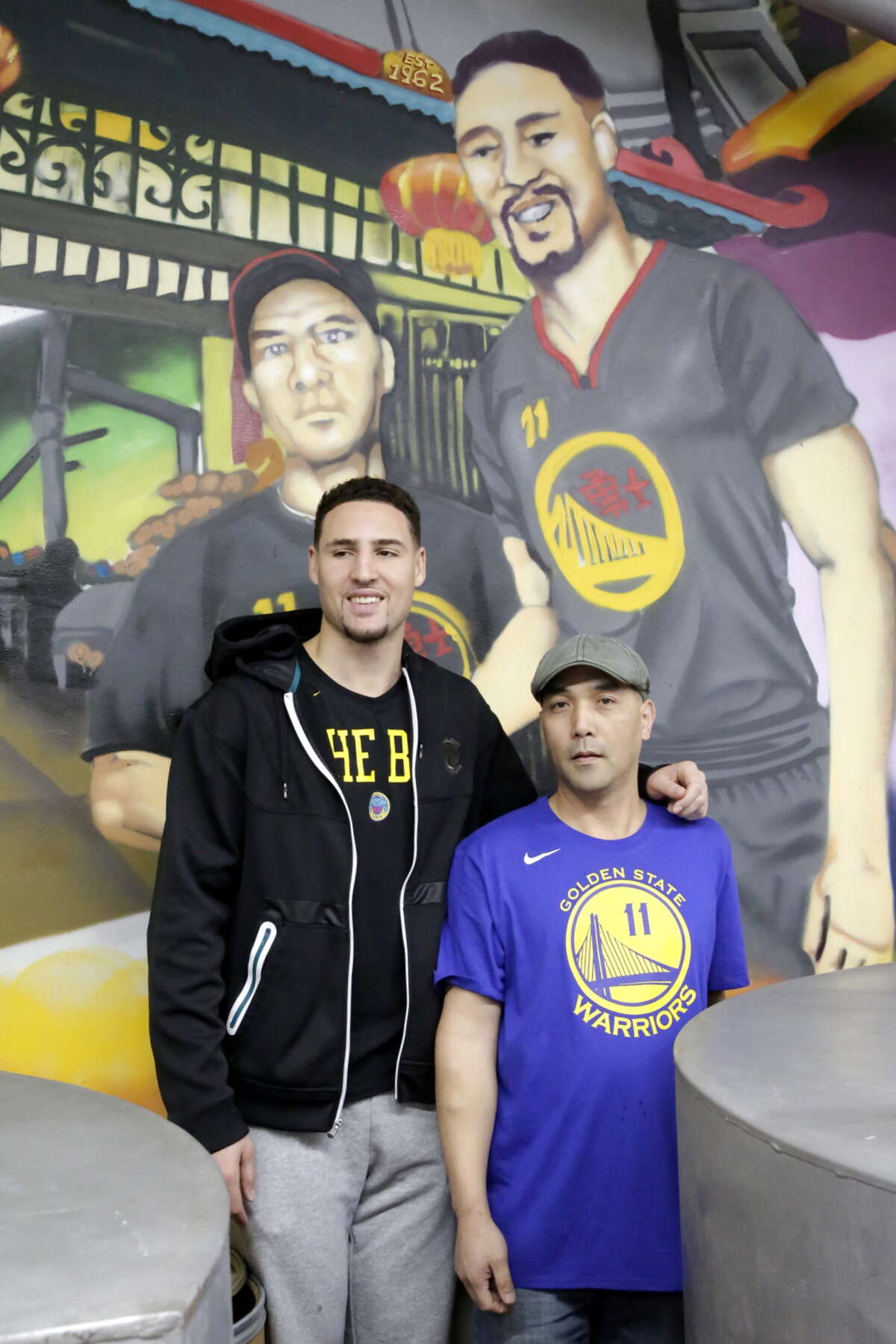 Golden State Warriors member Klay Thompson and Kevin Chan at the Golden Gate Fortune Cookie Factory in San Francisco.
