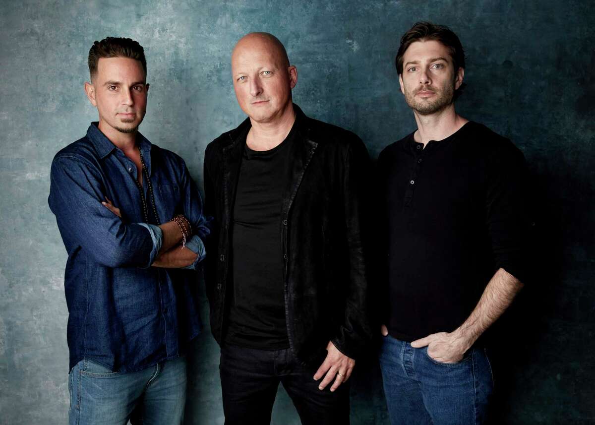 FILE - In this Jan. 24, 2019, file photo, Wade Robson, from left, director Dan Reed and James Safechuck pose for a portrait to promote the film "Leaving Neverland" during the Sundance Film Festival in Park City, Utah. The documentary premiered at the Sundance Film Festival. (Photo by Taylor Jewell/Invision/AP, File)